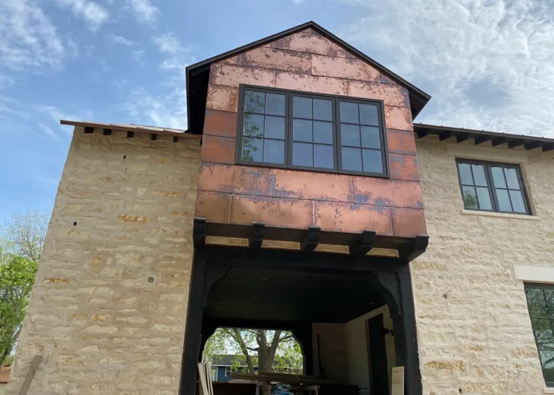Copper metal panel facade on a stone building for Skylight Installation in Gurnee